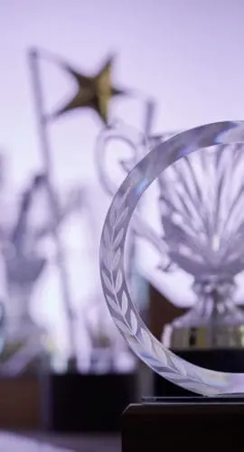 group of crystal trophies against purple background